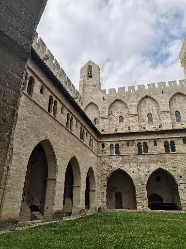Medieval cloister courtyard in Provence, stone arches and church walls on Christian heritage tour