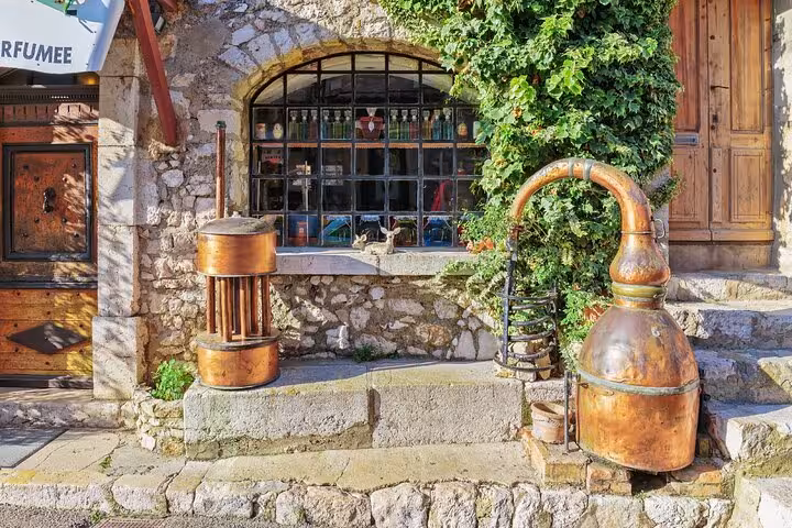 Historic distillery in a medieval village, featuring rustic stone walls and vintage copper equipment.