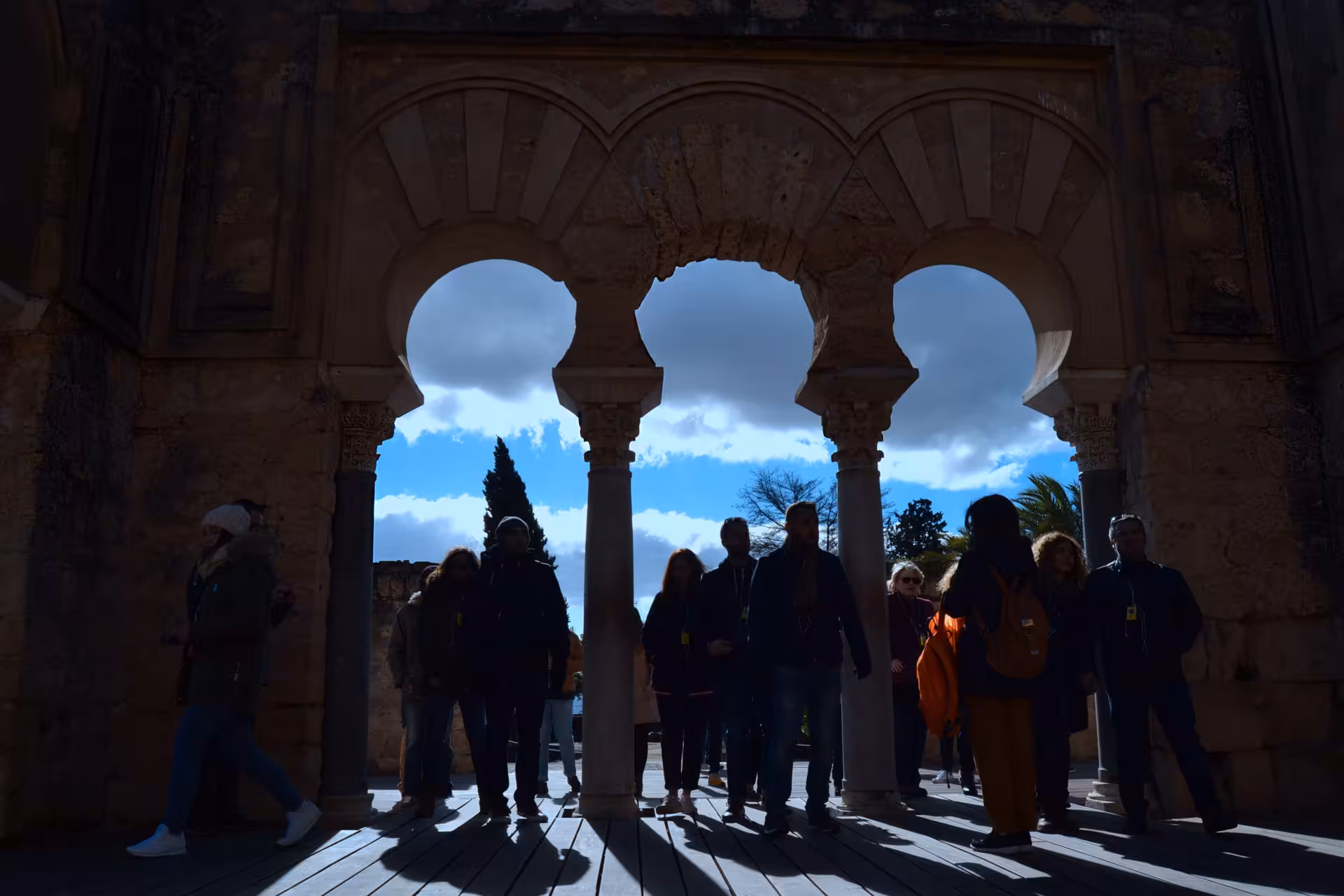 Visitors explore the iconic arches of Medina Azahara on a guided tour near Córdoba.
