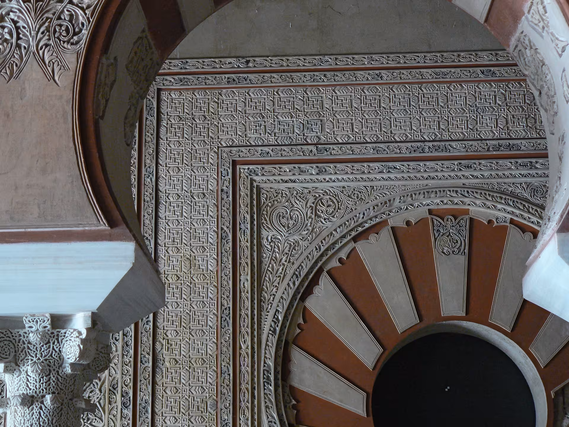 Intricate Islamic architectural details adorn the walls of Medina Azahara at night.