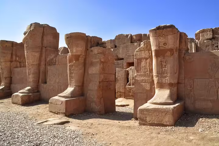 Colossal seated statues and carved sandstone ruins at Medinet Habu Temple, Luxor Valley of Workers tour