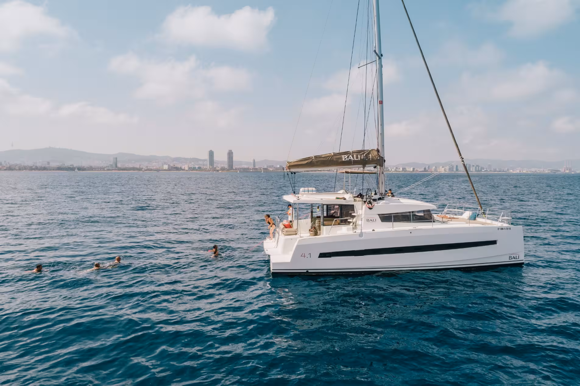 Mediterranean fishing charter catamaran on open sea near coastline, ideal for private boat trip and angling