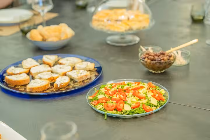 A vibrant spread of fresh salad, bruschetta, and olives, ideal for a Mediterranean seafood tasting event.