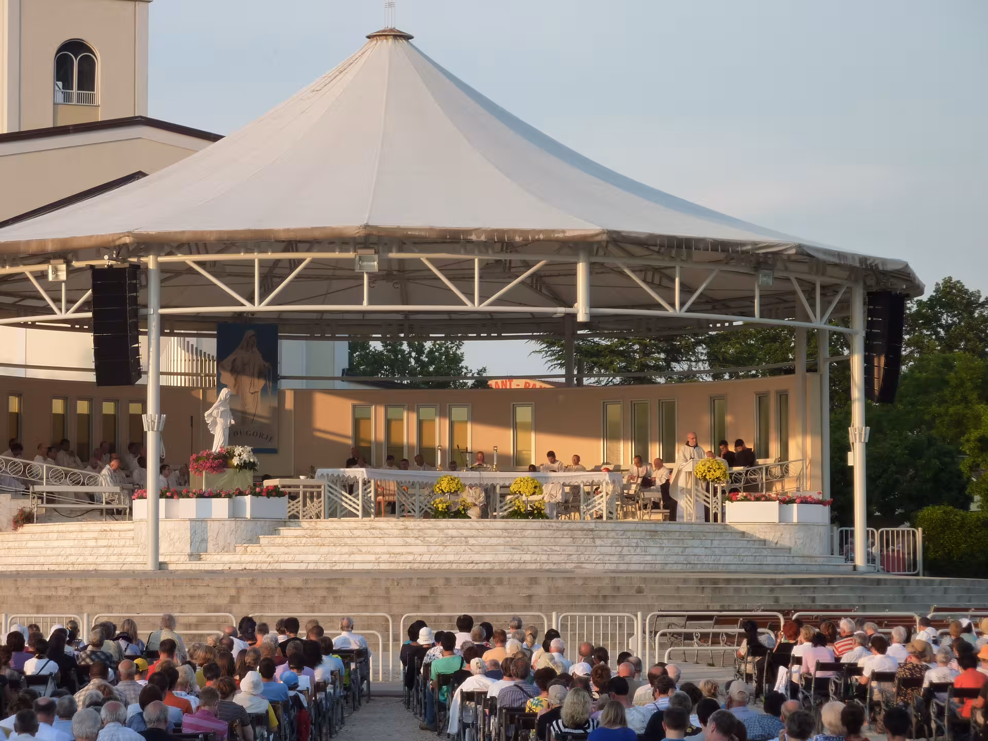 Pilgrims at Medjugorje outdoor Mass altar, key stop on Medjugorje Special from Split Exclusive Gems tour