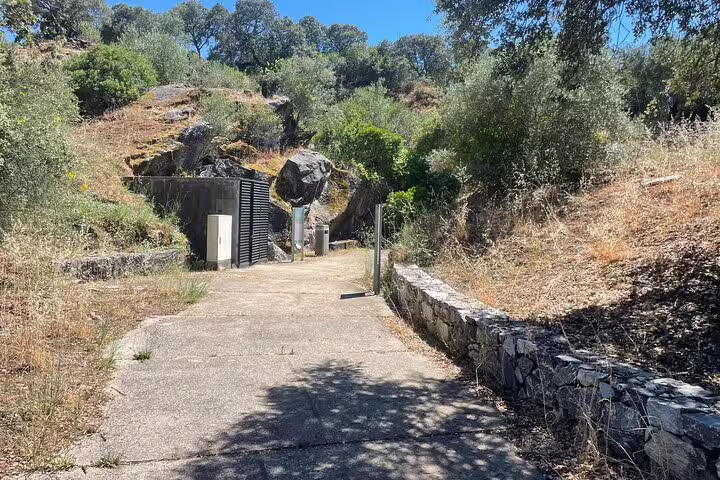 Scenic pathway through lush greenery and rocky terrain on the Full Day Megalithic Tour.