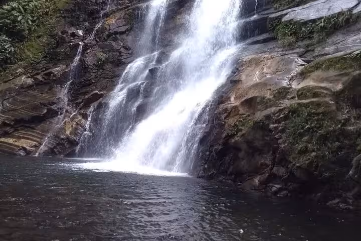 Close-up of Melancia Waterfall's cascading waters creating a misty atmosphere in Paraty, Brazil.