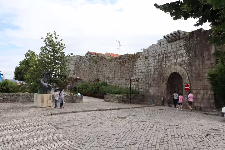 Historic stone walls and sculpture in Melgaço, Portugal, showcasing cultural heritage on a private Alvarinho wine tour.