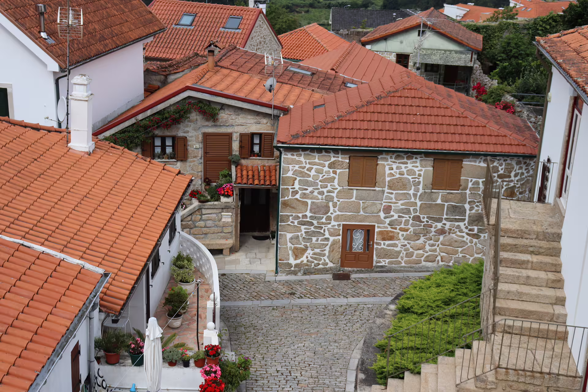 Charming village houses with stone walls and red roofs in Melgaço, showcasing the heart of the Alvarinho wine region.