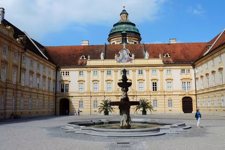 Melk Abbey courtyard fountain in Lower Austria, a highlight stop on a private Wachau Valley day trip from Vienna