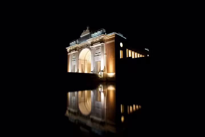 Menin Gate Memorial lit at night in Ypres, key stop on self-guided e-scavenger hunt city tour