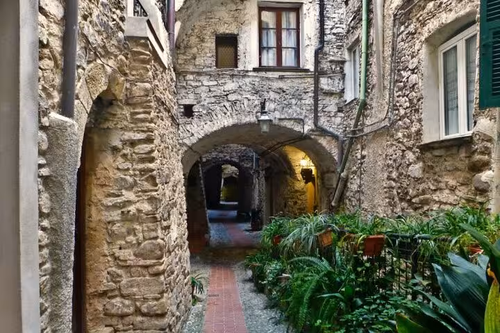 Charming stone alleyway in Menton, showcasing rustic architecture ideal for an Italian Coast and Monaco tour.