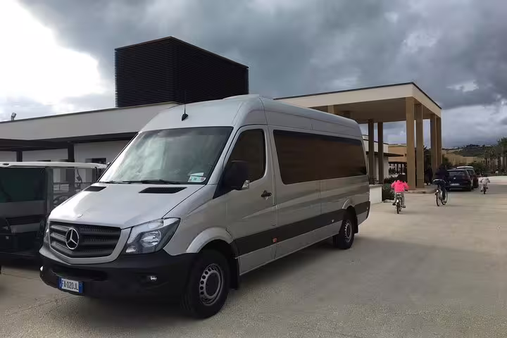 Comfortable Mercedes minibus parked at a hotel entrance in Agrigento, ready for private Palermo Airport transfer