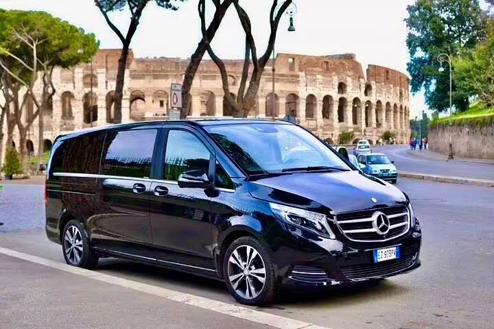 Luxury Mercedes minivan by the Colosseum in Rome providing round-trip private transfer for skip-the-line Vatican and city tour