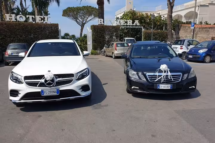 Elegant white and black Mercedes cars parked at Hotel Riviera for private transfer service to Sorrento.