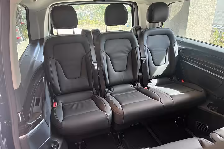 Spacious and comfortable leather seating inside a Mercedes van for private transfer from Bologna to Florence.