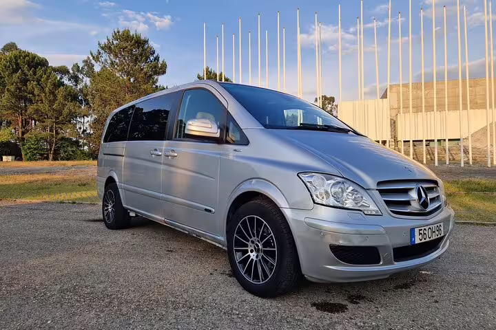 Spacious Mercedes van for comfortable private transfer between Porto and Santiago de Compostela, parked in a serene setting.