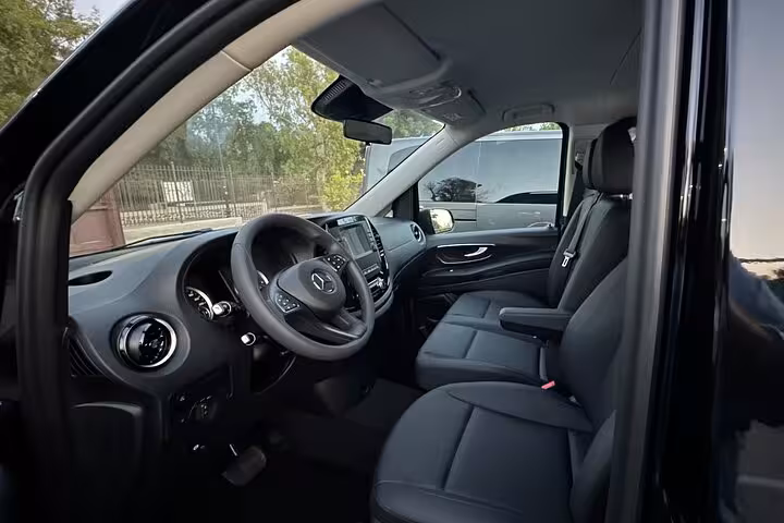 Spacious interior of a Mercedes van featuring modern amenities for a comfortable transfer from Positano to Rome.
