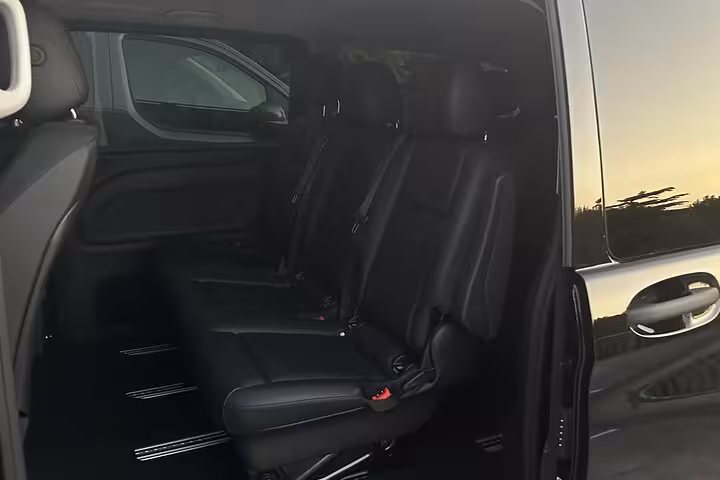 Rear seating of a Mercedes van highlighting ample space and comfort for private transfer from Positano to Naples.