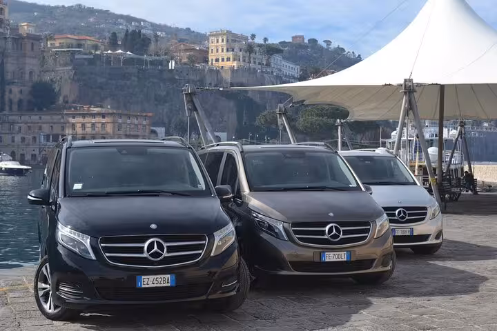 Fleet of Mercedes vans ready for private transfer service from Sorrento to Positano.