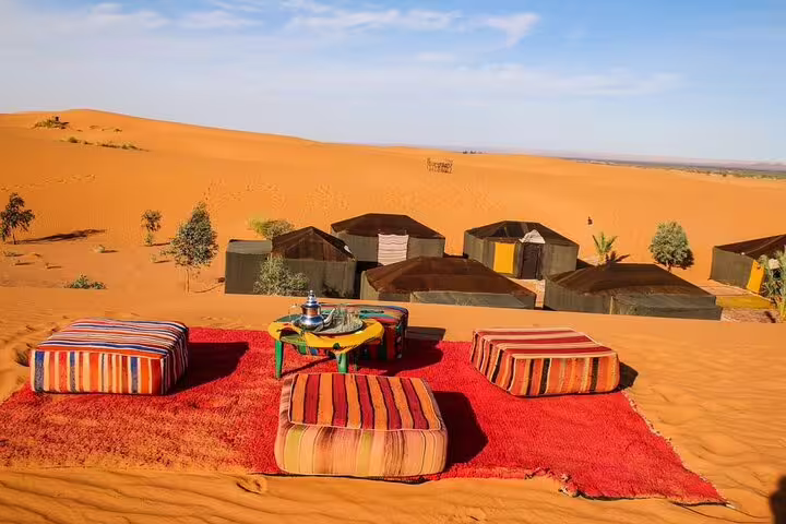 Merzouga Sahara desert camp lounge with tea and cushions, highlight of 3 days desert tour Fes to Marrakech