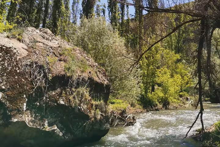 Lush riverside valley with flowing stream and rock outcrops, nature stop on Mesopotamia and Cappadocia private tour