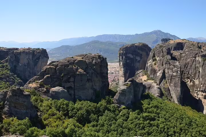 Panoramic view of Meteora's rugged cliffs and lush valleys, showcasing Greece's natural beauty on a private tour from Athens.
