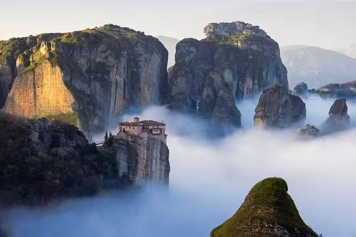 Meteora monasteries above sea of clouds, iconic view on a private day trip from Athens to Kalambaka, Greece