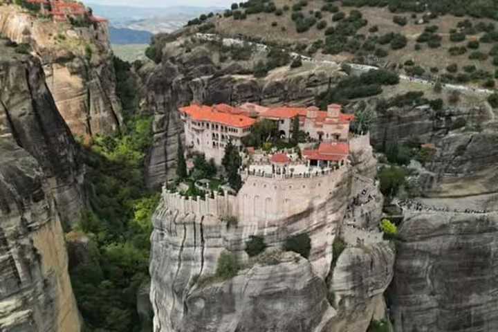 Aerial view of Meteora monastery complex atop cliffs, scenic stop on a private day trip from Athens to Meteora