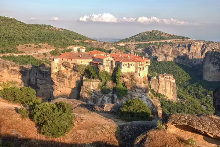 Meteora monastery perched on towering cliffs, iconic stop on Thermopylae Meteora Delphi private full-day tour