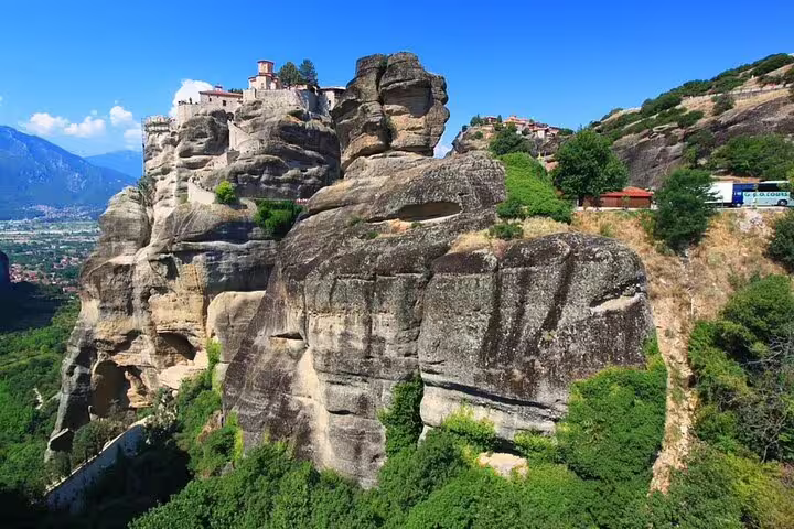 Meteora cliffside monastery atop towering sandstone rocks, scenic stop on private day tour from Athens