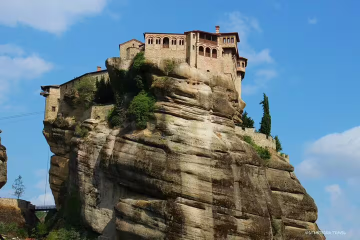 Meteora monastery perched on towering rock pillar, highlight of a 2-day private tour to Delphi and Thermopylae