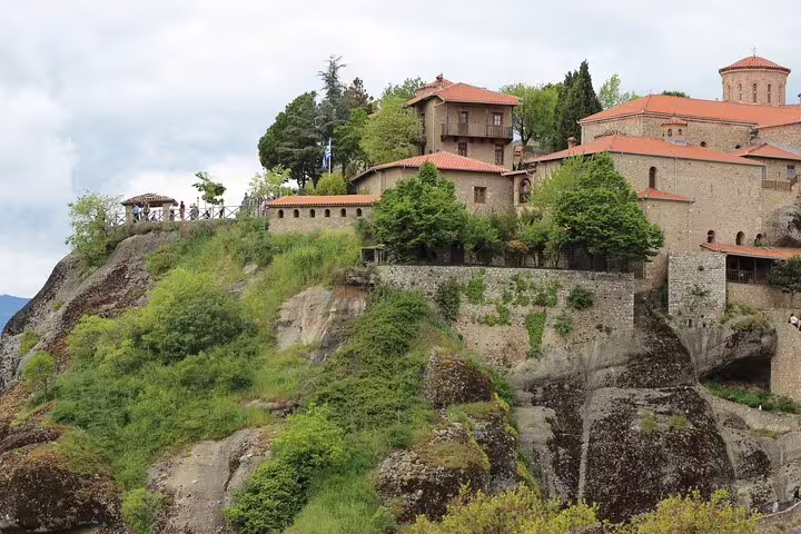 Hilltop Meteora monastery complex with red-tiled roofs and lookout terrace, on a private full-day monasteries tour