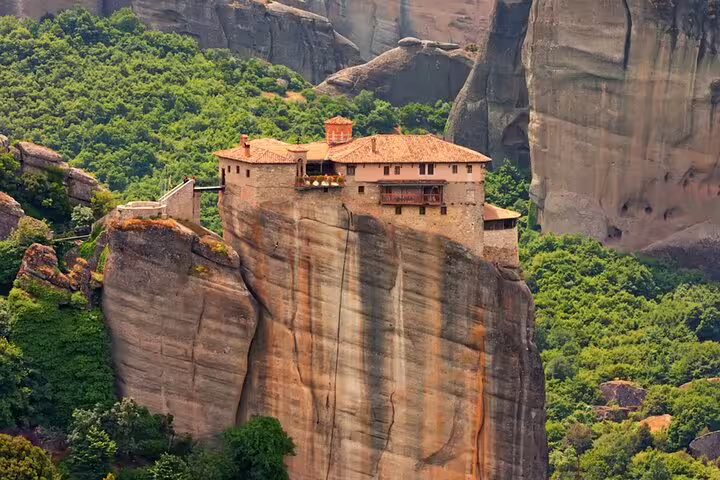 Close-up of Meteora monastery atop dramatic rock pillar, must-see on Meteora private day tour from Athens