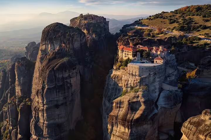 Meteora cliffside monastery at sunset on a 2-day private tour from Athens to Thermopylae and Delphi
