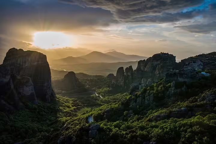 Sunset over Meteora rock formations and valley, panoramic highlight on private full-day tour from Athens