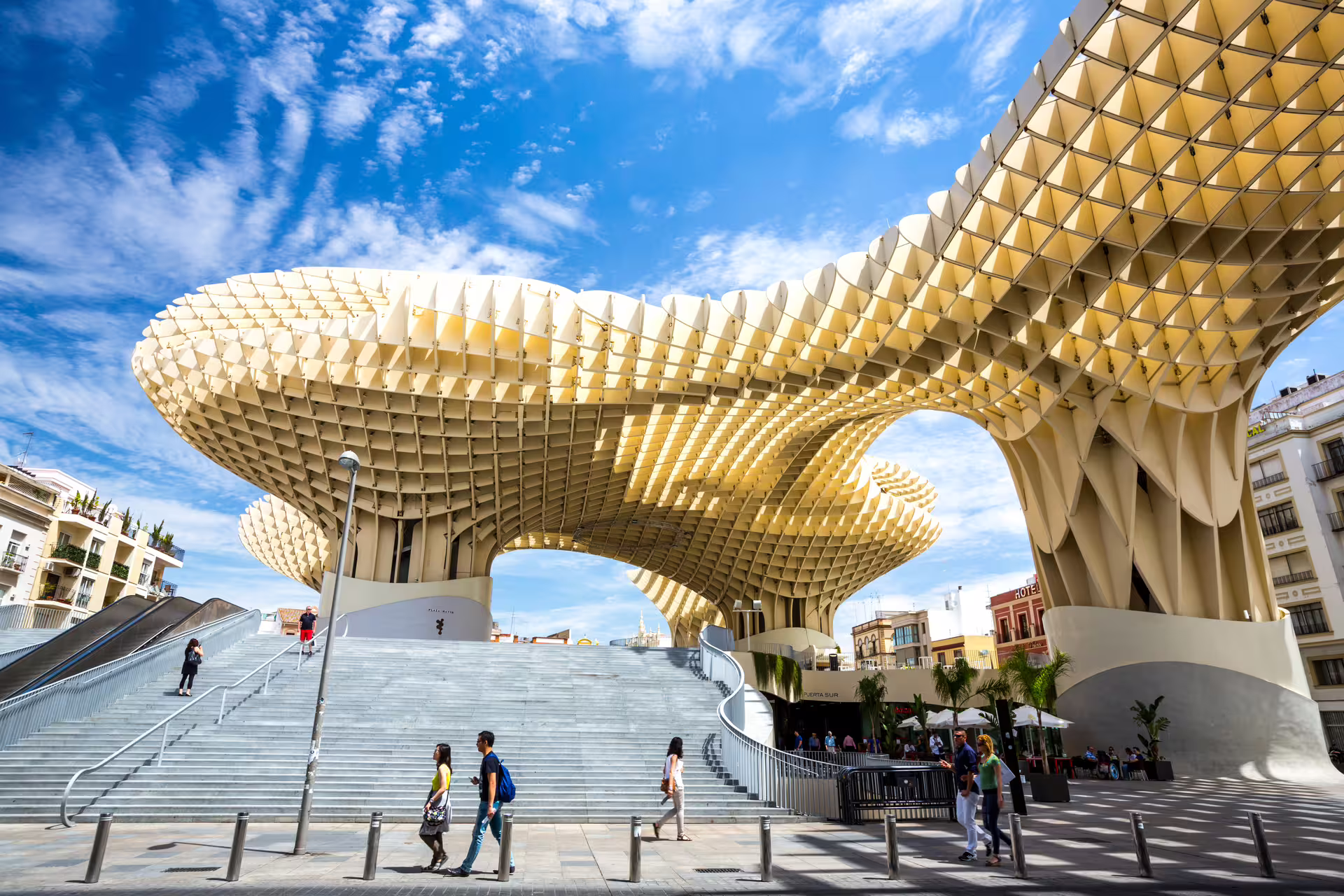 Metropol Parasol in Seville, Spain, with tourists exploring its modern architecture on a sunny day, ideal for small group walking tours.