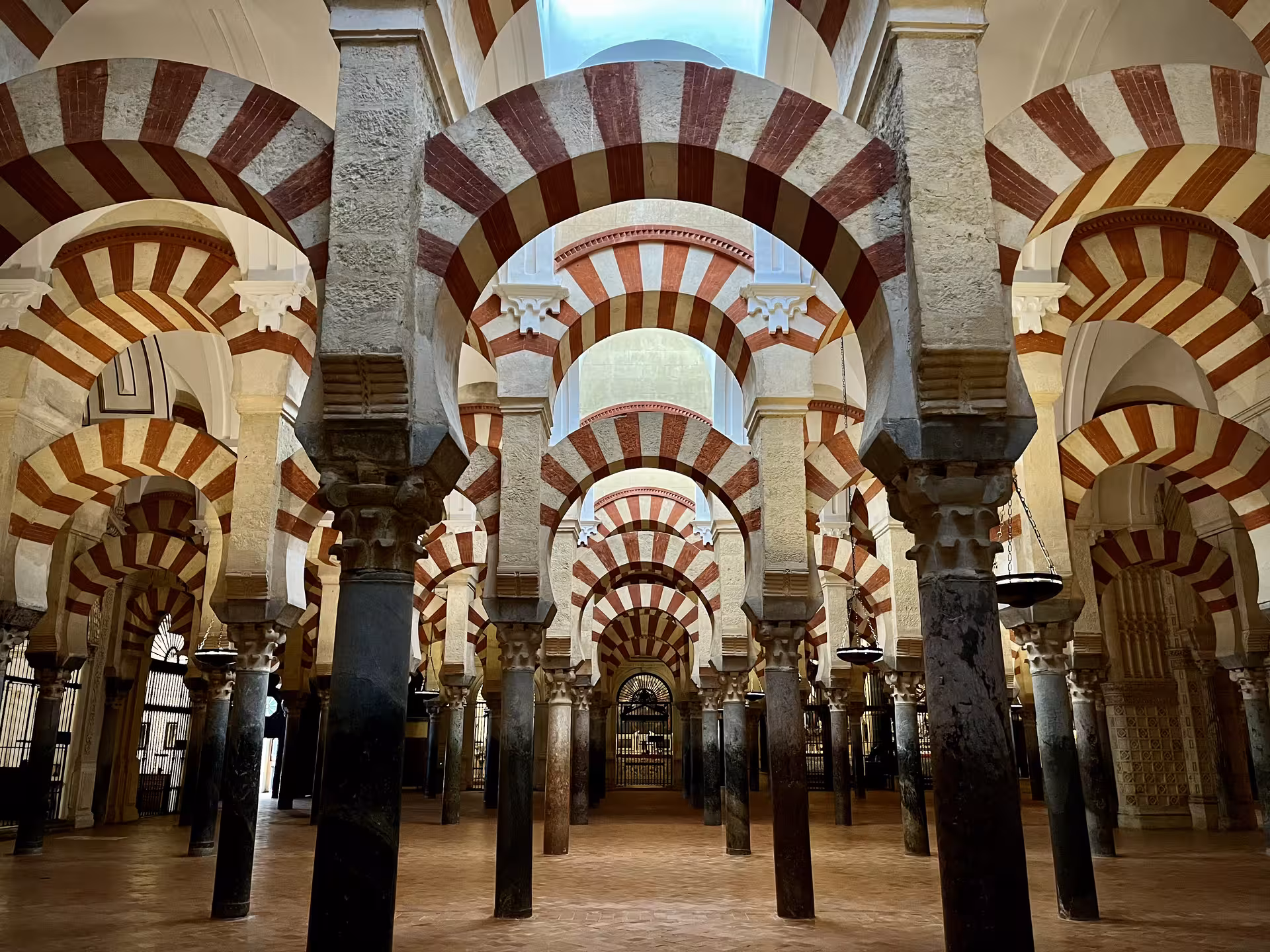 Forest of red-and-white arches inside the Mezquita of Córdoba on a Monumentos Locales guided tour