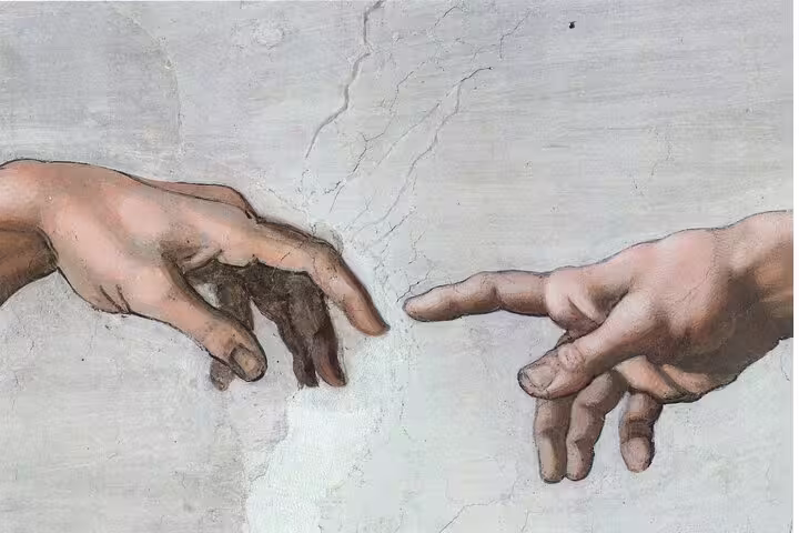 Close-up of Michelangelo’s Creation of Adam hands in Sistine Chapel on expert guided Vatican tour