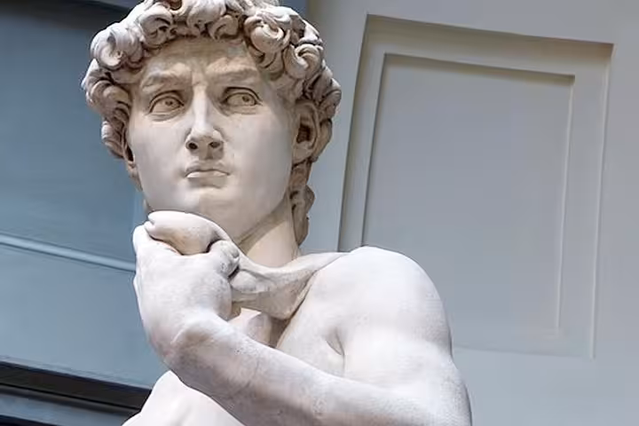 Close-up of Michelangelo's David showcasing intricate details during a guided tour at the Accademia Gallery.