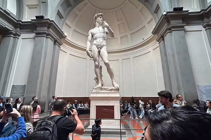 Tourists admire Michelangelo’s David inside Florence’s Galleria dell’Accademia on an exclusive VIP guided tour
