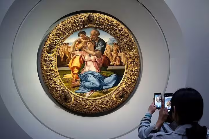 Visitor photographing Michelangelo’s Doni Tondo in the Uffizi Gallery on a Florence Uffizi and Accademia skip-the-line combo tour