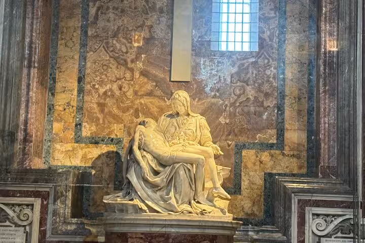Michelangelo's Pietà sculpture in St Peter's Basilica, highlighting Renaissance artistry on a private small group tour.