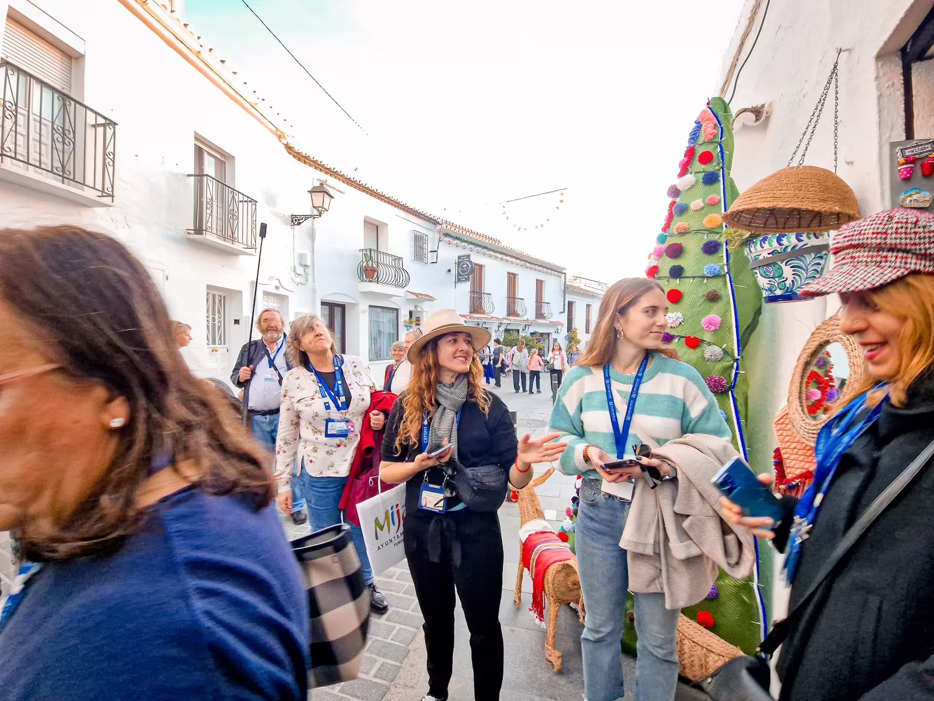 Tour guests browsing crafts in Mijas Pueblo streets on a private Mijas day trip from Costa del Sol