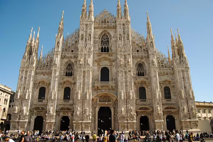 Tourists gather at the iconic Milan Cathedral, a highlight of the Milano walking tour featuring the Duomo, Castle, and gelato delights.
