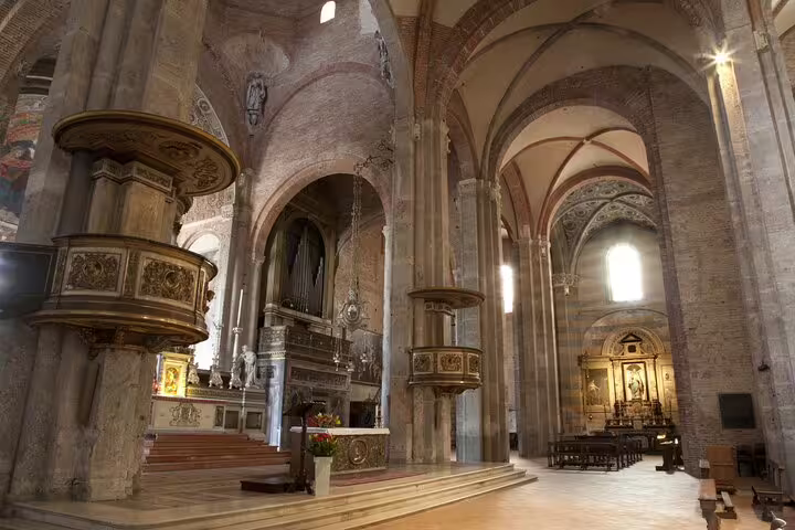 Interior view of a historic Milan cathedral, featuring ornate architecture and grand arches, perfect for a private city tour.
