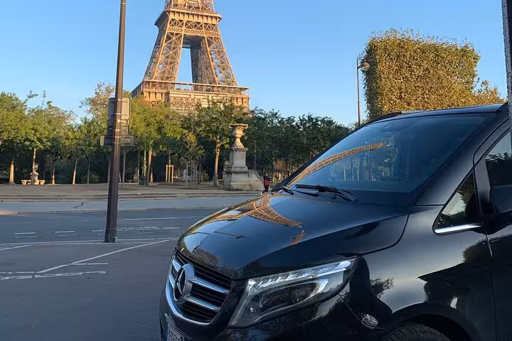 Premium van with Eiffel Tower backdrop on route from Milan to Courchevel private transfer.