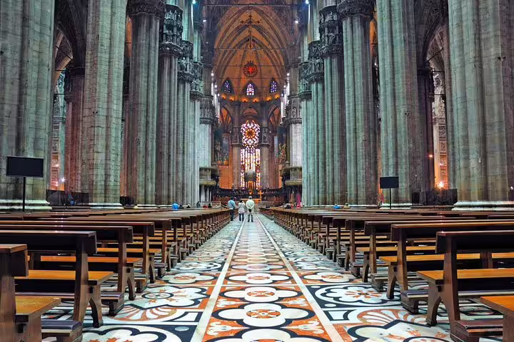 Interior of Milan Duomo Cathedral with ornate marble floor, soaring columns and altar, visited on a private guided tour