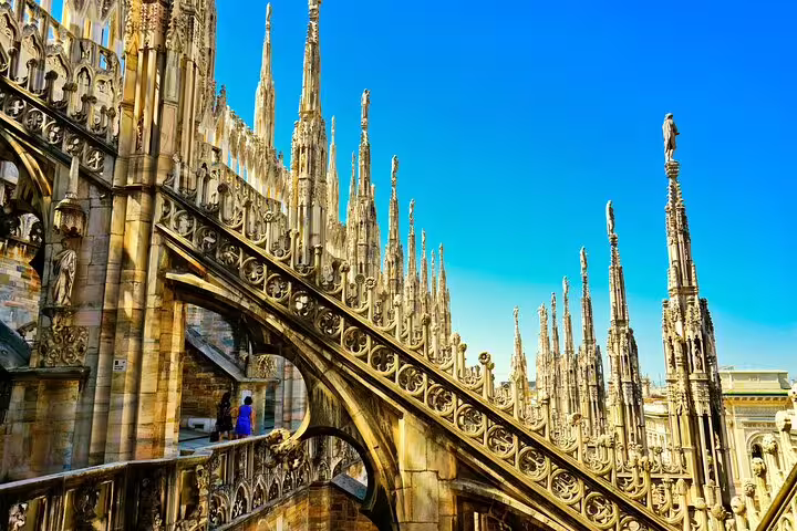 Detail of the ornate rooftop terraces of Milan Duomo, with Gothic spires and statues visited on a guided private city tour