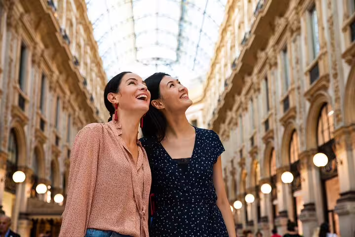 Two women enjoy the architecture inside Galleria Vittorio Emanuele II during a private walking tour in Milan, Italy.