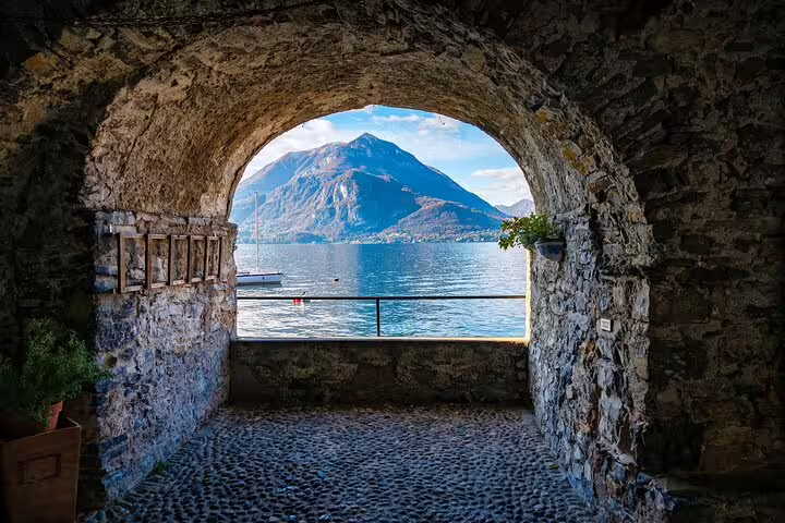 Stone arch viewpoint over Lake Como and mountains, scenic stop on Milan to Lake Como private day tour